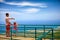 Happy father and son, tourists enjoying the fascinating view on Atlantic ocean coastline from observation deck of Pico Isabel de T