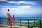 Happy father and son, tourists enjoying the fascinating view on Atlantic ocean coastline from observation deck of Pico Isabel de T