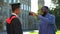 Happy father taking smartphone photo of glad graduating son with diploma, event