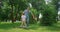 Happy father teaching son play soccer. Cheerful boy passing ball to dad on lawn.