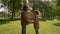 Happy father touching noses with smiling daughter in golden sunlight portrait.