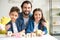 happy father with two children holding cubes with word family and smiling