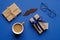 Happy Fathers Day concept. Flat lay composition with gift box, greeting card and cup of coffee, mustache on blue background