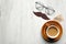 Happy Fathers Day concept. Happy Father`s Day inscription, mustache, cup of coffee and male glasses on wooden table top view.