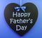 Happy Fathers Day message written on a heart shape black blackboard