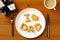 Happy Fathers Day table setting concept. Father`s Day brunch with homemade bakery I love Dad on plate, gift box, cup of coffee on