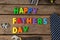 Happy fathers day text by neckties and work tools on table