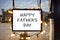 Happy Fathers Day written on hanging sign surrounded by party lights in shop window with semi-transparent dark solar shades behind