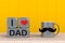 Happy Fatherâ€™s Day message, Close up of coffee with mustache and heart on yellow wood background