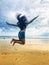 Happy feet girl, jumping on beach sand