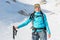 Happy female alpinist posing in the mountains covered with snow.