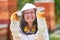 Happy female apiarist holding honeycomb