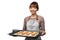 happy female in apron with cookies on oven tray