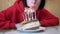 Happy Female Blows out the Candles on a Piece of Birthday Cake. Slow motion