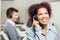 Happy Female Call Center Agent Using Headset In