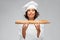 Happy female chef with french bread or baguette