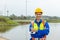 Happy female engineer of wind turbine energy company. woman holding wind turbine simulator. Technology protect environment reduce