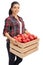 Happy female farmer holding wooden crate filled with apples