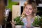 Happy female florist looking at flower pot