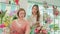 Happy female Florist workers partner in a colorful flower shop.