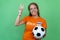 Happy female football fan from Holland with orange jersey