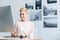 happy female freelancer drawing on graphic tablet at table in home