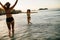 Happy female friends playing at beach