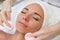 Happy female getting facial massage alternative medicine top view