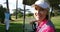 Happy female golfer sitting in golf buggy