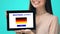 Happy female holding tablet with learn German language test, educational app
