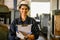 Happy female industrial worker holding clipboard paperwork