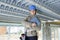 Happy female manufacturing labourer holding clipboard