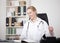 Happy Female Medical Doctor Sitting at her Office