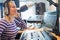 Happy female radio host broadcasting in studio