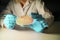 Happy Female Reasercher picking up colony of a red bacterial culture from agar plate wearing green gloves in a molecular biology