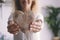 Happy female showing hand made wooden heart at the camera with smile in background. Concept of love and artisan decoration shabby