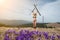 Happy female skier is enjoying warm spring, wearing swimsuit, boots and sunglasses