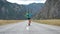 Happy Female Tourist With Backpack Is Turning On Place In Mountains Background