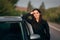 Happy Female Tourist Driver Next to Her Car