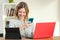 Happy female using multiple colorful devices at home