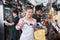 Happy Female Worker Slicing Cheese With Knife In Shop