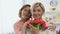 Happy females looking in camera holding tulip flowers, international women day