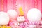 Happy fifth birthday cake and number five candle with pink and white balloons, anniversary