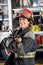 Happy Firewoman Holding Walkie Talkie Against