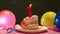 Happy first birthday cake and pink number one candle with balloons