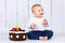 Happy first birthday, studio portrait of cute toddler and a birthday cake