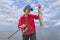 Happy fisher girl with walleye zander fish trophy at the boat