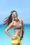 Happy fit beach girl wearing sunglasses in fitness sportswear