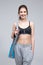 Happy fit woman standing with yoga mat