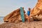 Happy fit woman sunbathing on beach. Surfboard for active leisure. Adventure, summer vacation and surf idea. Copy space